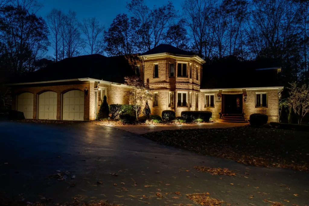 Home at night with a custom outdoor lighting design