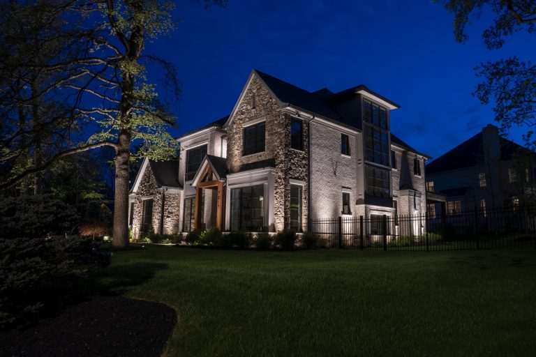 Wall grazing and tree uplighting on the side of a modern McLean, VA home