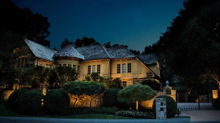 Landscape lighting on a stone McLean, VA home at dusk